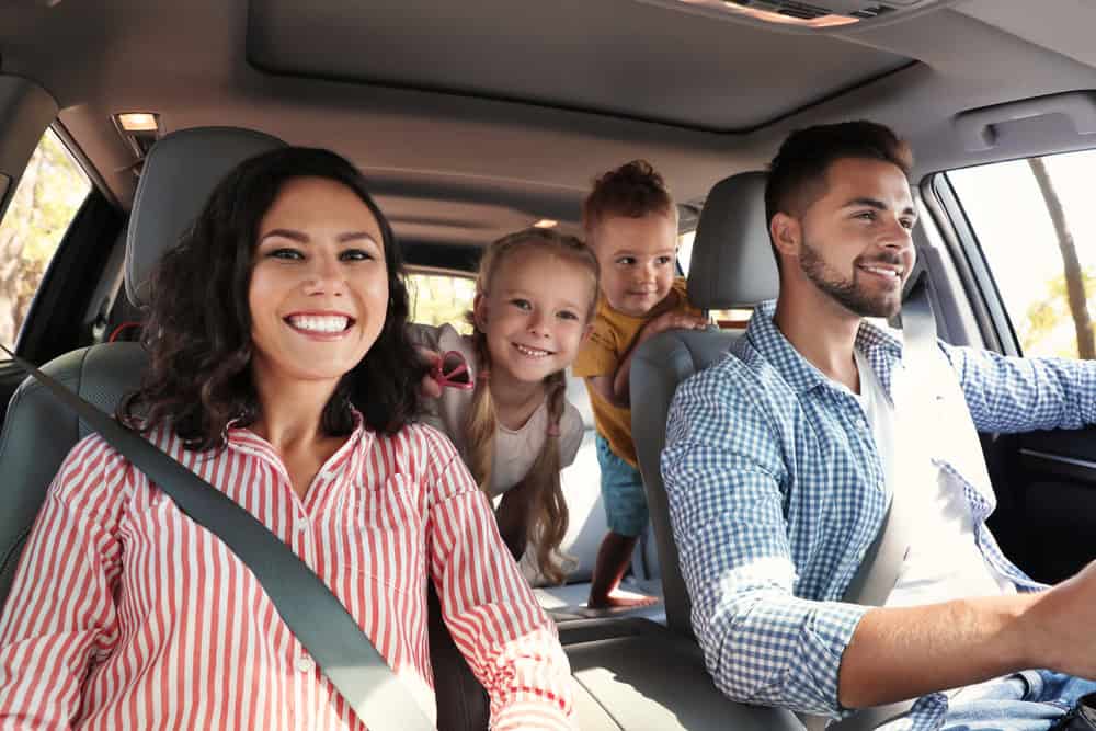 Holiday Vehicle Maintenance | European Car Care | Motoring Specialists Vacaville. Image of mom turned around singing with kids in luxury car.