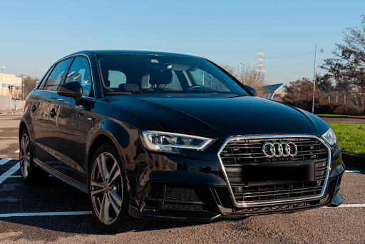 Independent Audi Auto Repair Shop in Vacaville, CA with Motoring Specialists. Image of black Audi sedan parked sideways in a parking lot.
