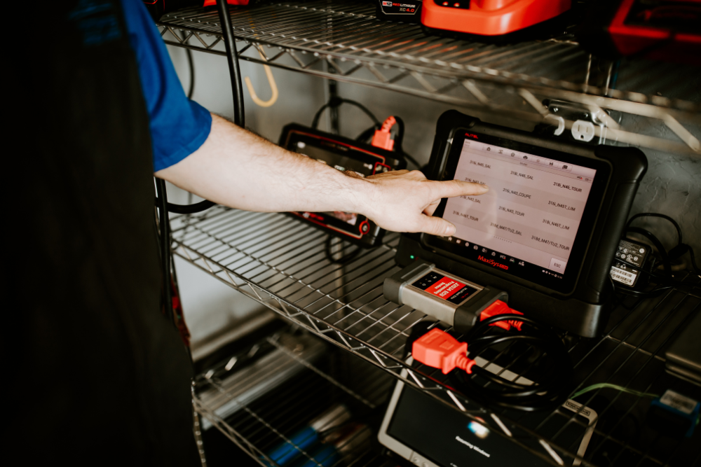 Digital Vehicle Inspection in Vacaville, european auto repair in Vacaville, CA at Motoring Specialists. Automotive technician selecting diagnostic data on a Maxisys scanner.