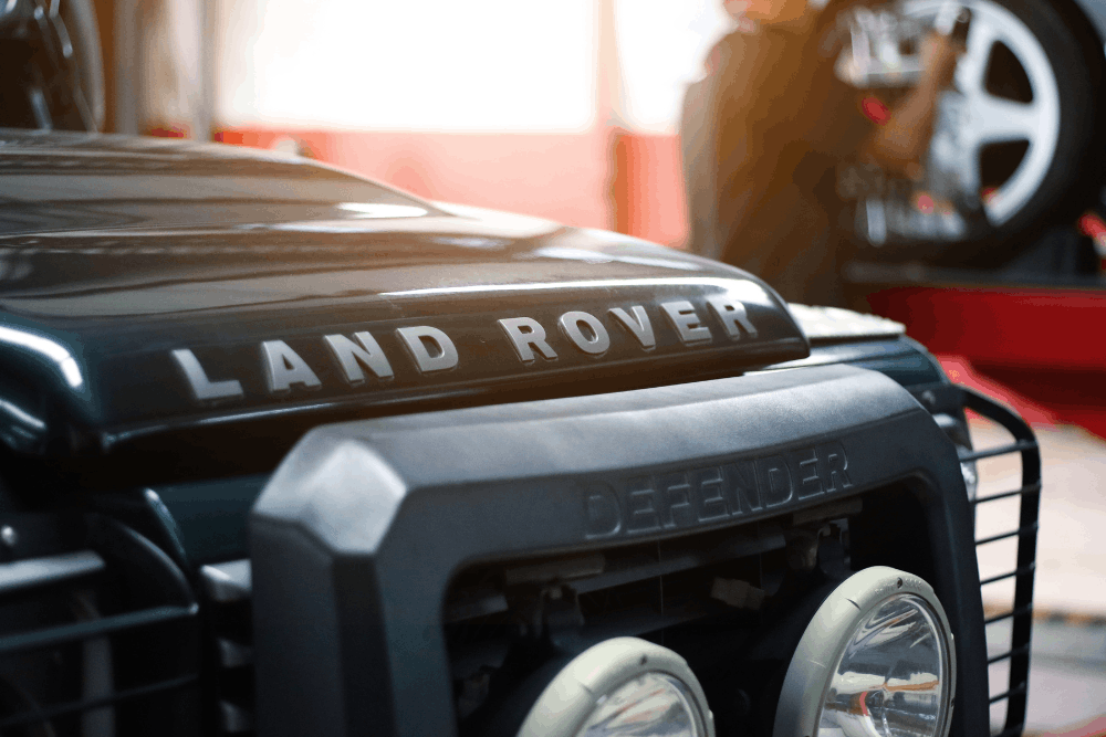 Land Rover repair, auto repair in Vacaville, CA by Motoring Specialists. Image of a Land Rover Defender in a repair bay, emphasizing trusted maintenance and service for European SUVs.